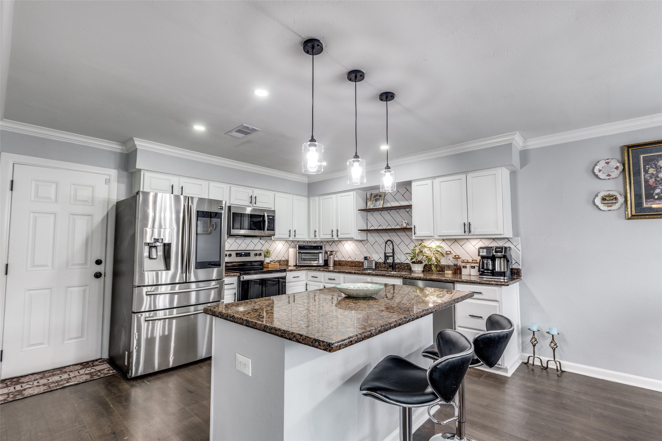 605 South Remington Drive Angleton, TX 77515 - Photo 10 of 25 a kitchen with stainless steel appliances granite countertop a refrigerator a stove a sink and a center island