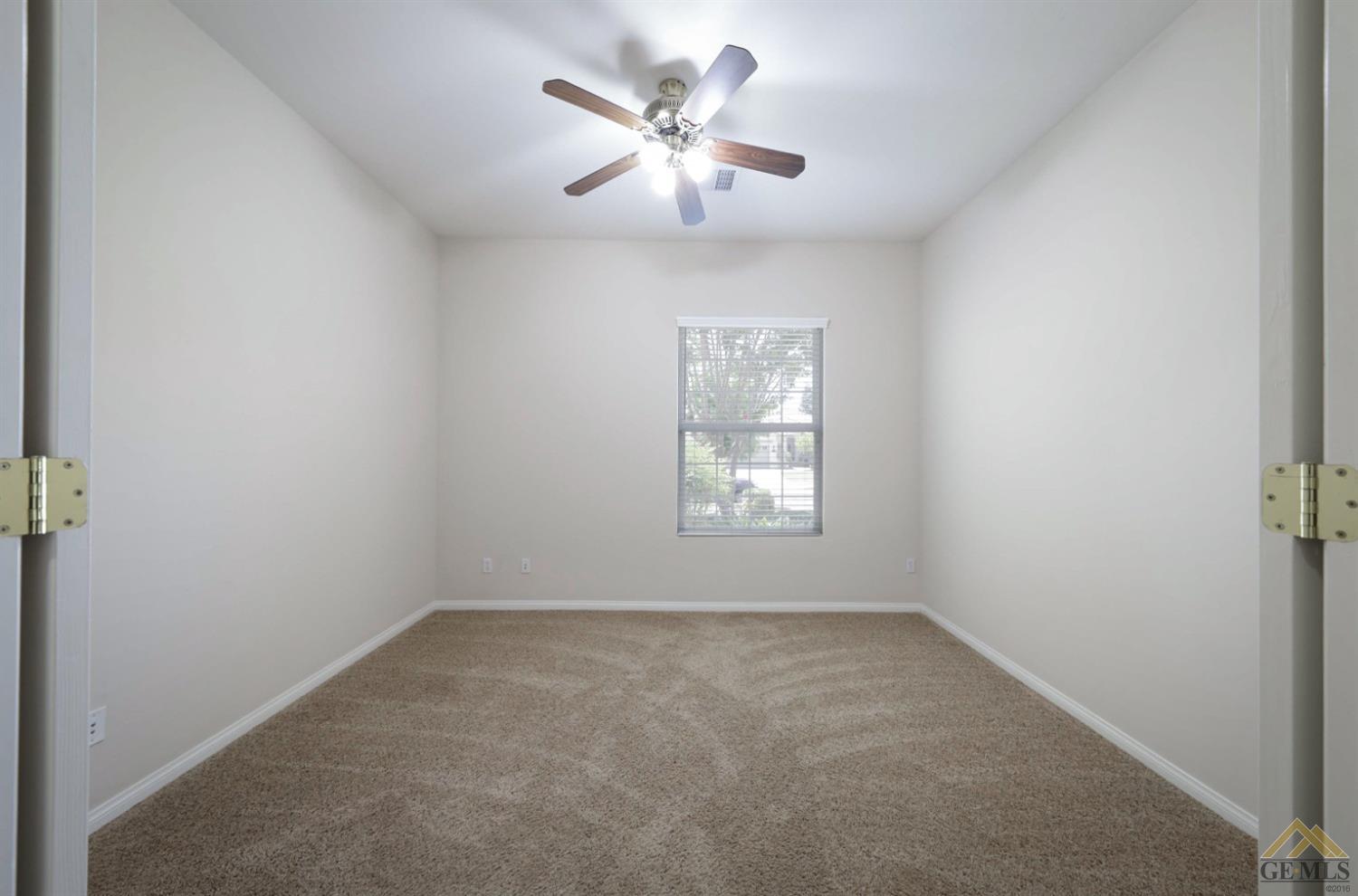 Undisclosed Address Bakersfield, CA 93311 - Photo 11 of 34 an empty room with windows and fan