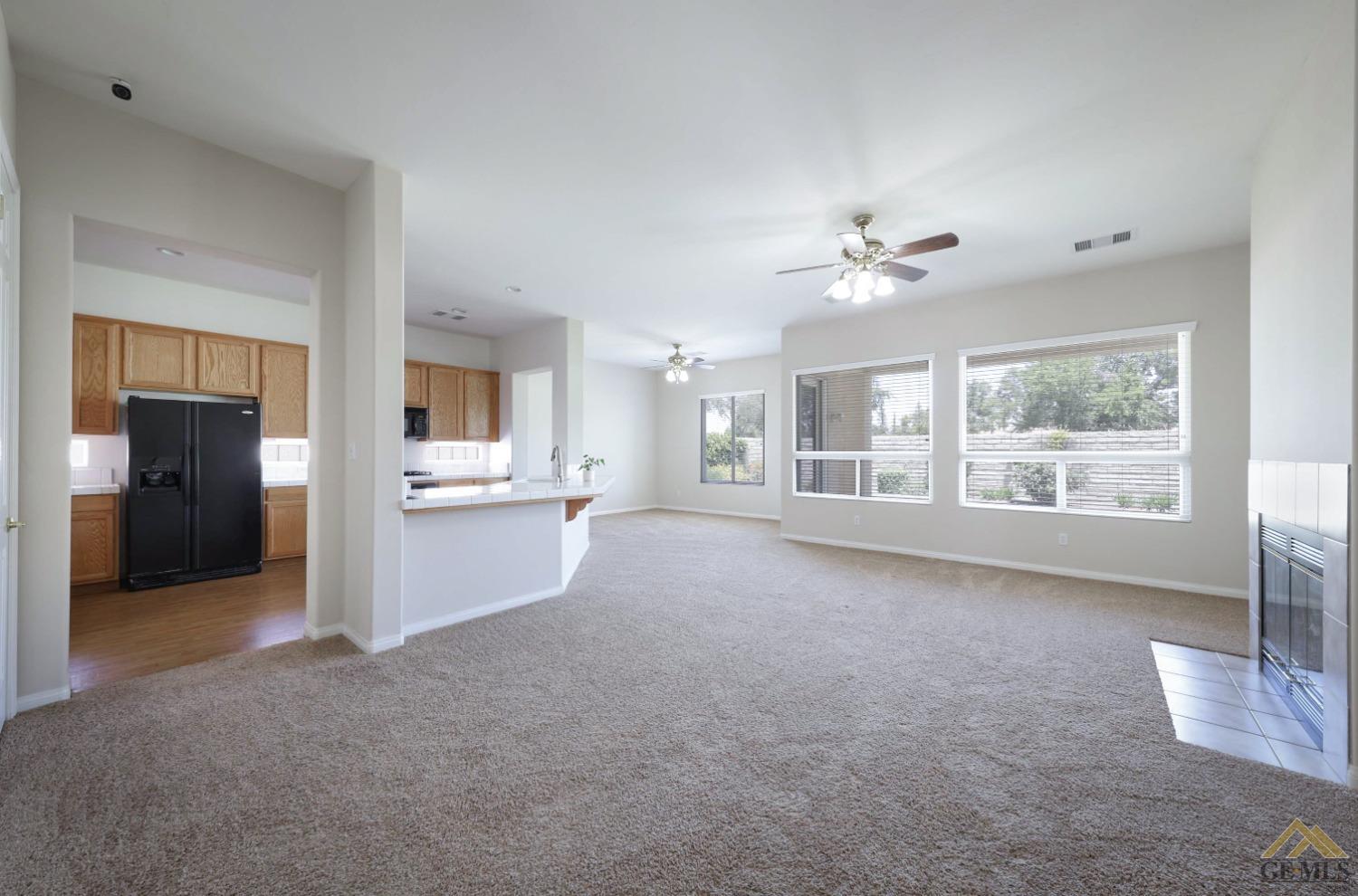 Undisclosed Address Bakersfield, CA 93311 - Photo 16 of 34 a view of a big room with windows and chandelier fan