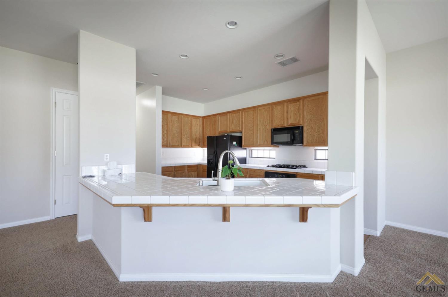 Undisclosed Address Bakersfield, CA 93311 - Photo 18 of 34 a close view of kitchen island with granite countertop sink