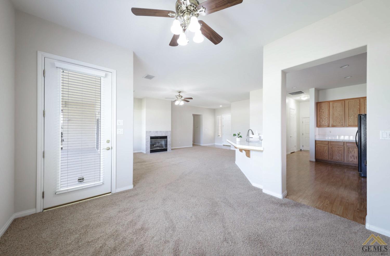 Undisclosed Address Bakersfield, CA 93311 - Photo 19 of 34 a view of a big room with a chandelier fan and windows
