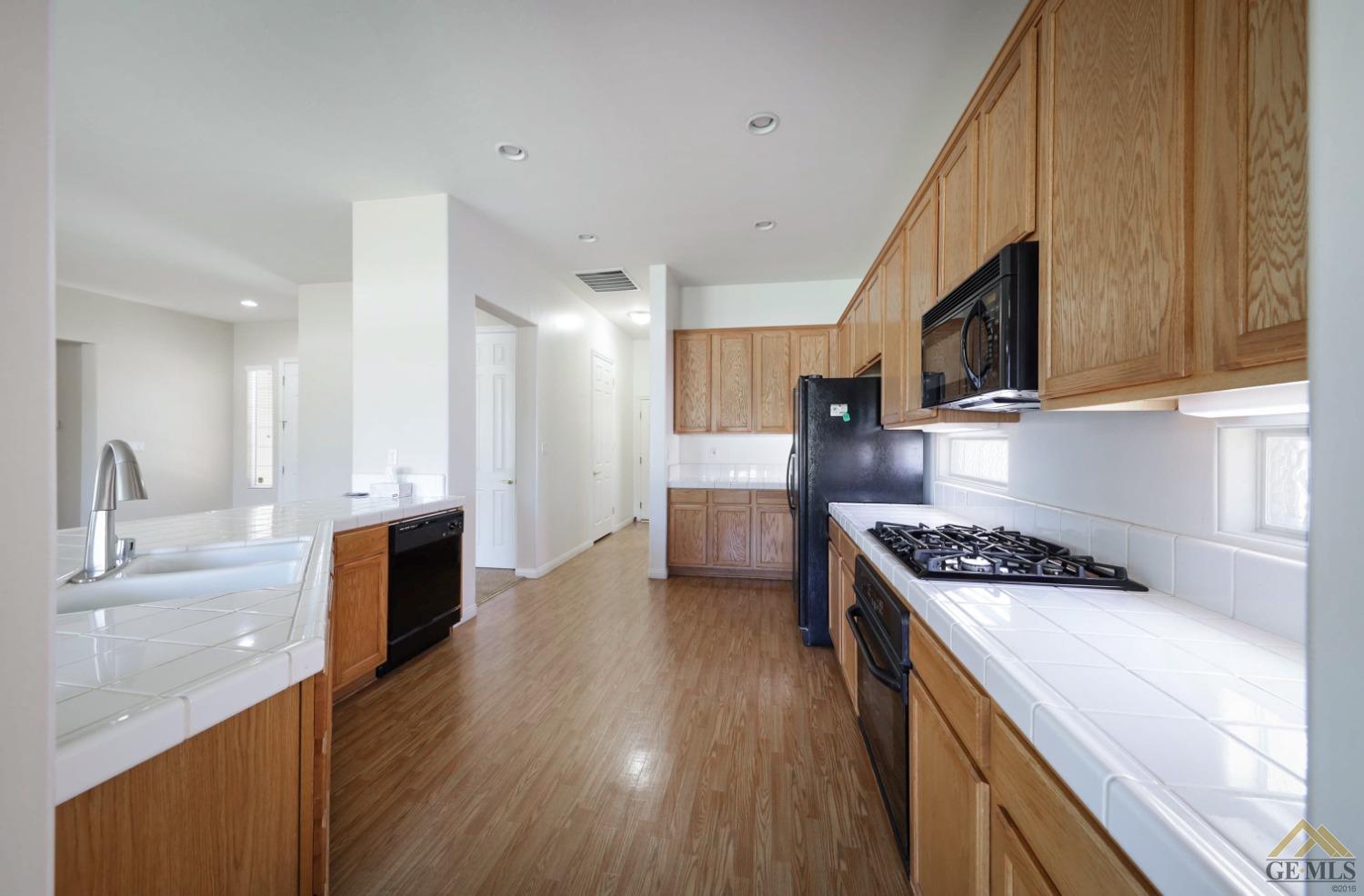 Undisclosed Address Bakersfield, CA 93311 - Photo 20 of 34 a kitchen with stainless steel appliances granite countertop a sink stove and refrigerator
