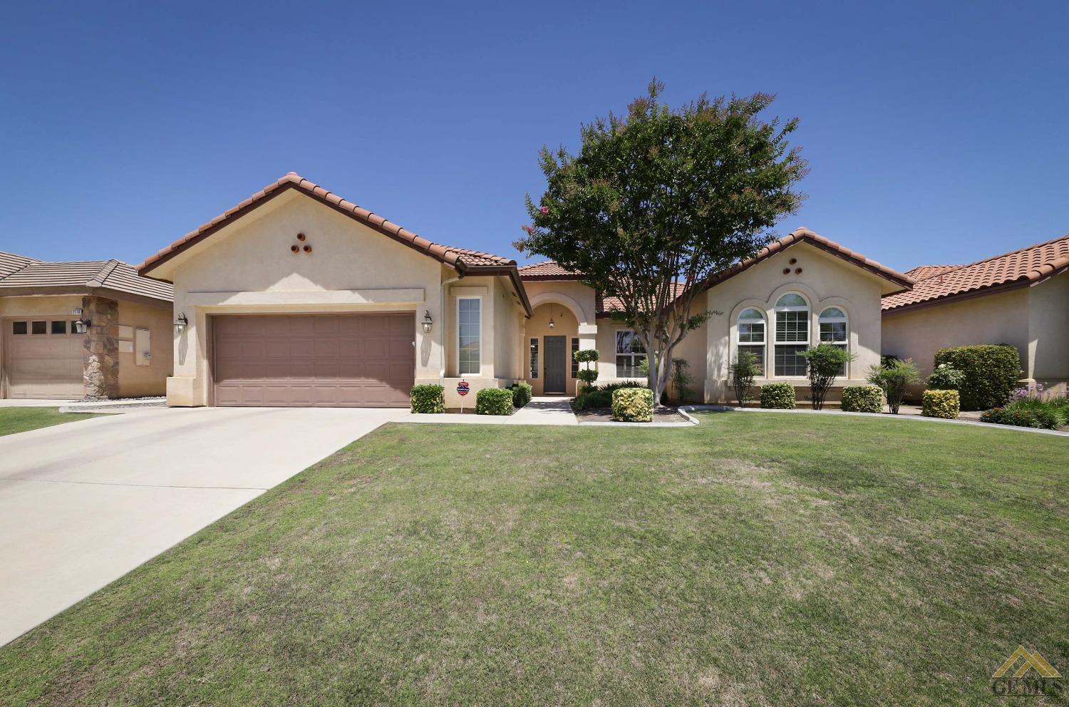Undisclosed Address Bakersfield, CA 93311 - Photo 2 of 34 a front view of a house with a yard and garage