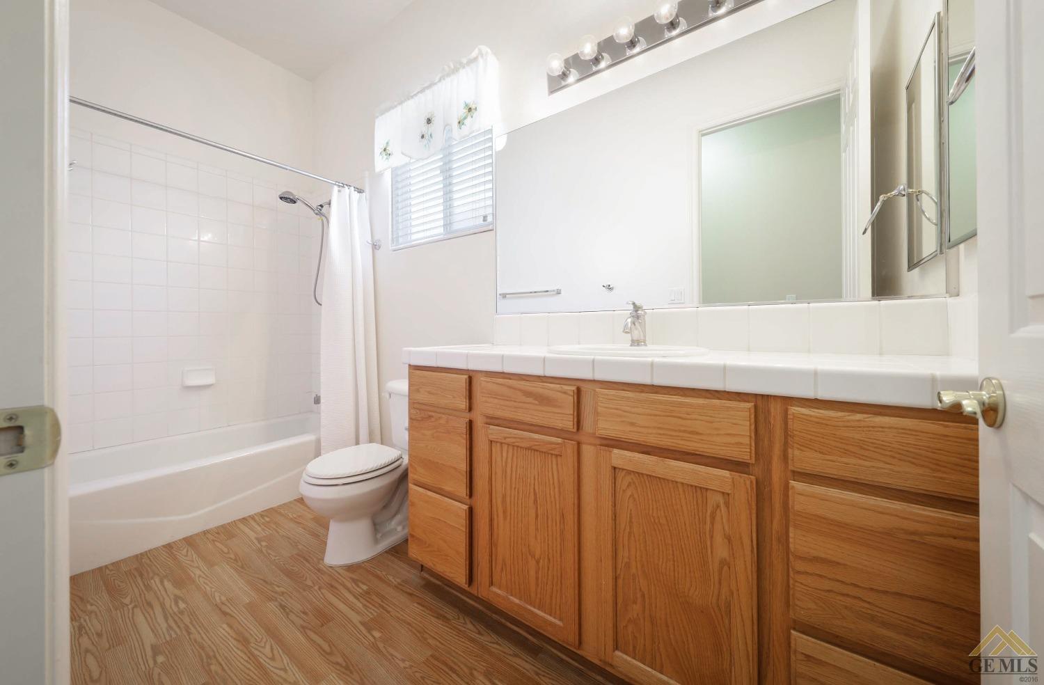 Undisclosed Address Bakersfield, CA 93311 - Photo 24 of 34 a bathroom with a sink a toilet and shower