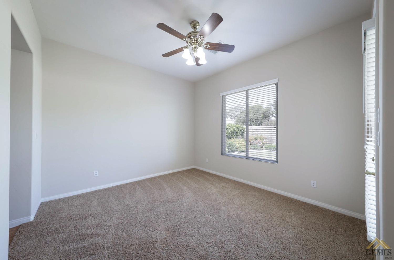 Undisclosed Address Bakersfield, CA 93311 - Photo 27 of 34 an empty room with windows and ceiling fan