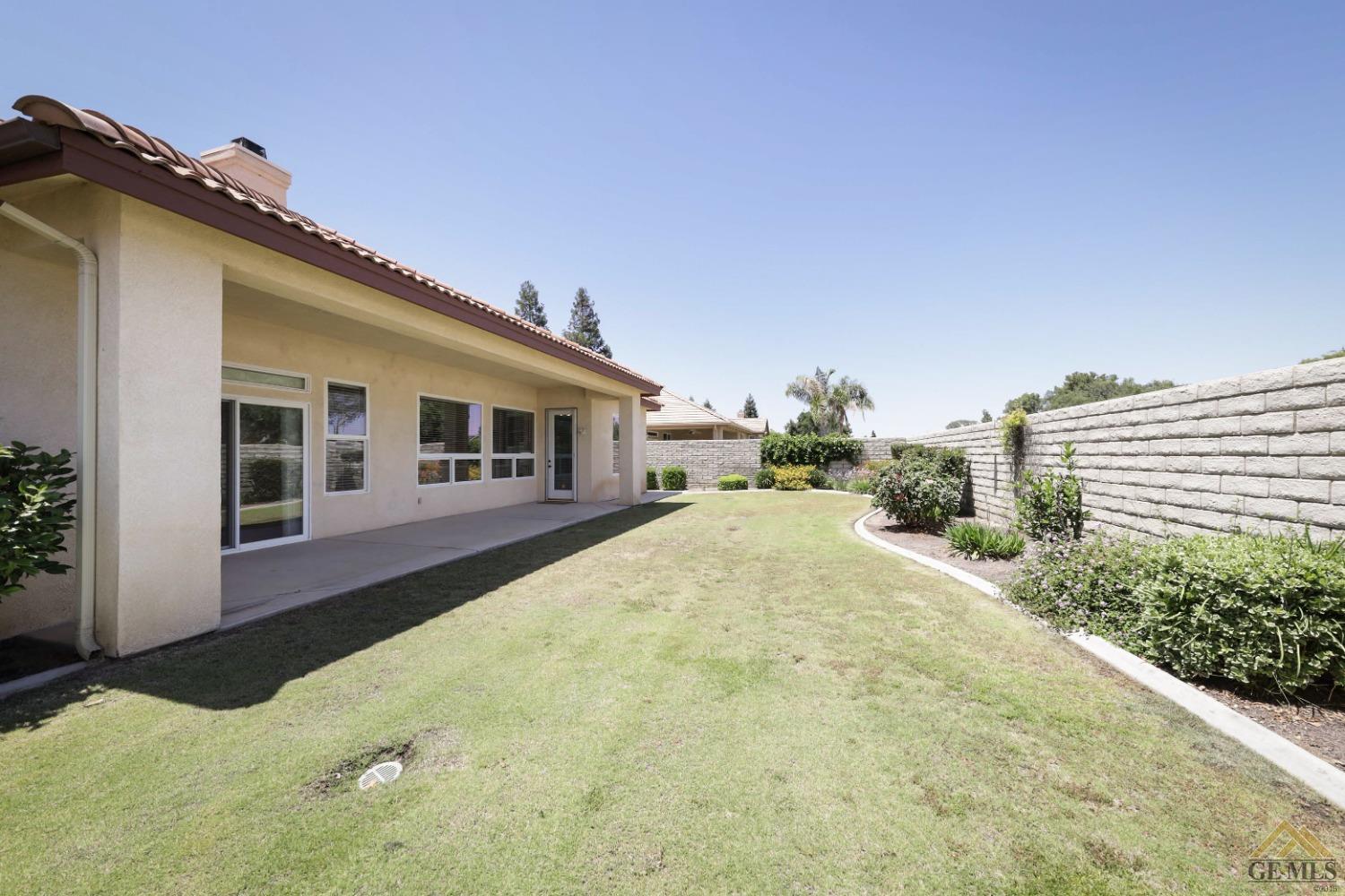 Undisclosed Address Bakersfield, CA 93311 - Photo 31 of 34 a yellow house with trees in front of it