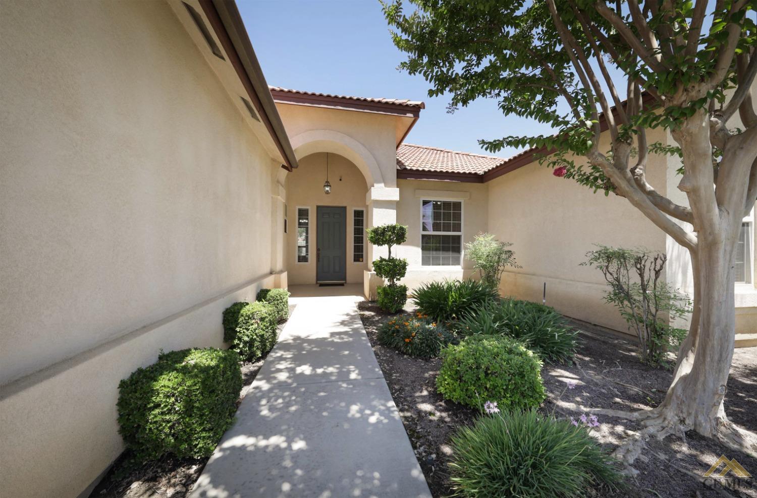 Undisclosed Address Bakersfield, CA 93311 - Photo 7 of 34 a front view of a house with a yard