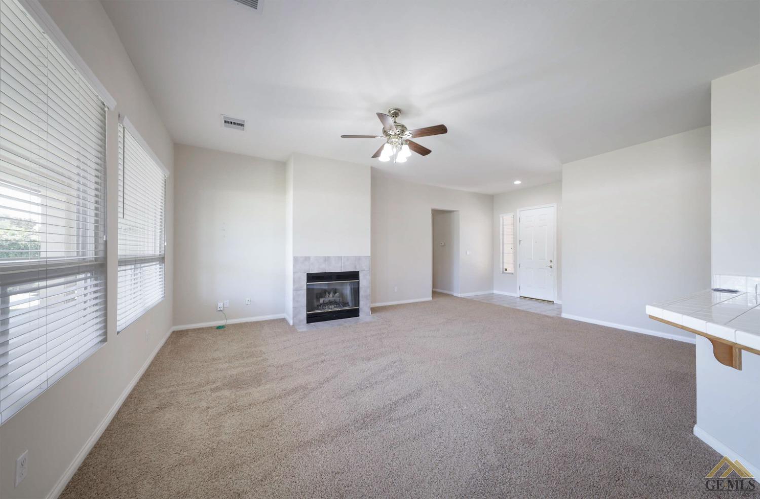 Undisclosed Address Bakersfield, CA 93311 - Photo 9 of 34 wooden floor in an empty room with a fireplace