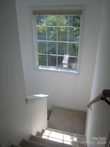 a bathroom with a granite countertop toilet a sink and a mirror