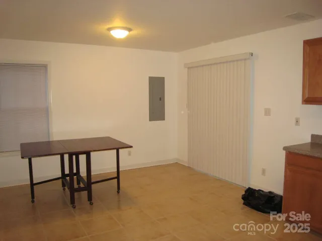 a kitchen with granite countertop a refrigerator and a sink