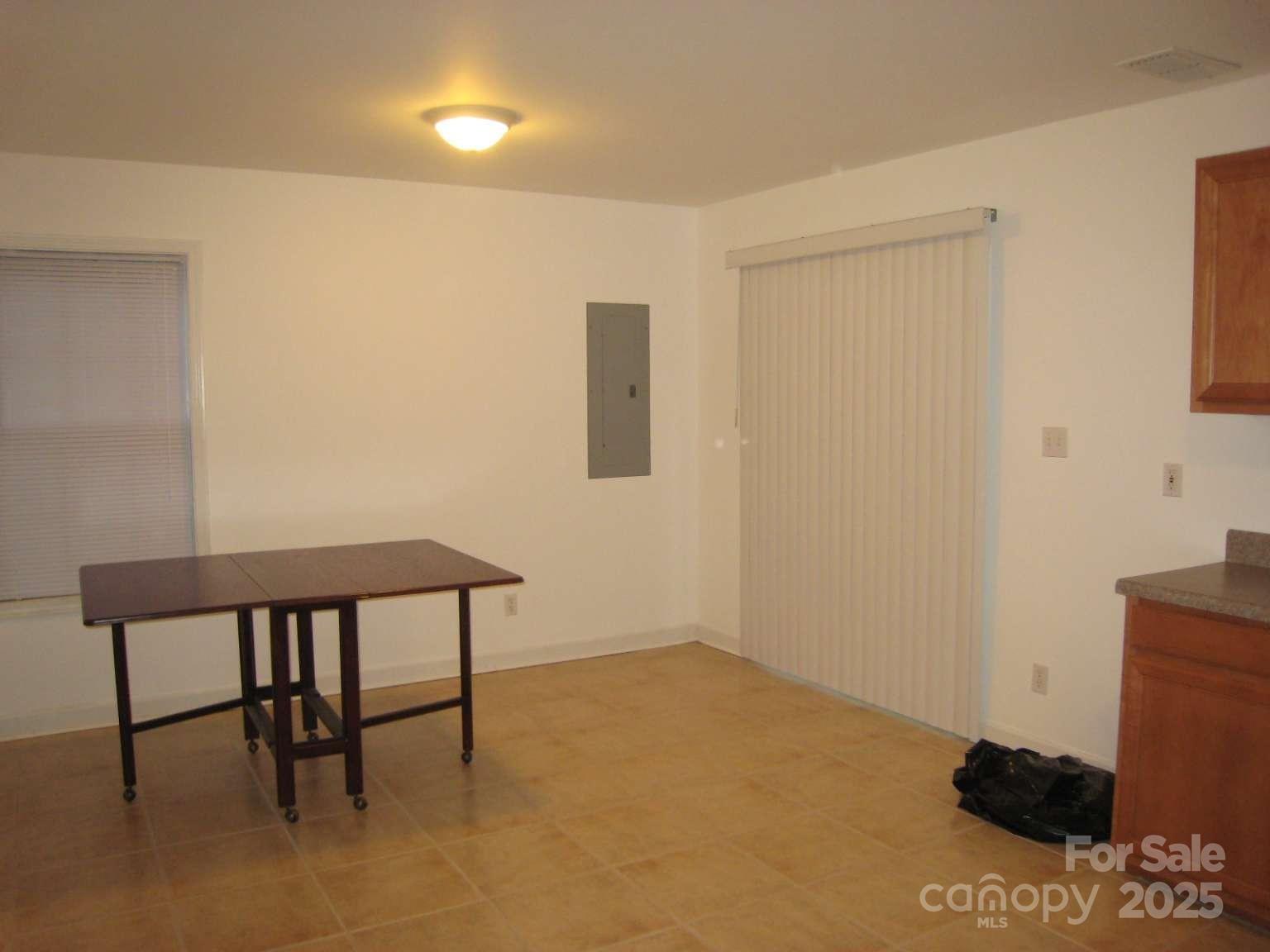 4653 Perkins Road Charlotte, NC 28269 - Photo 8 of 16 a view of a room with a table and chairs