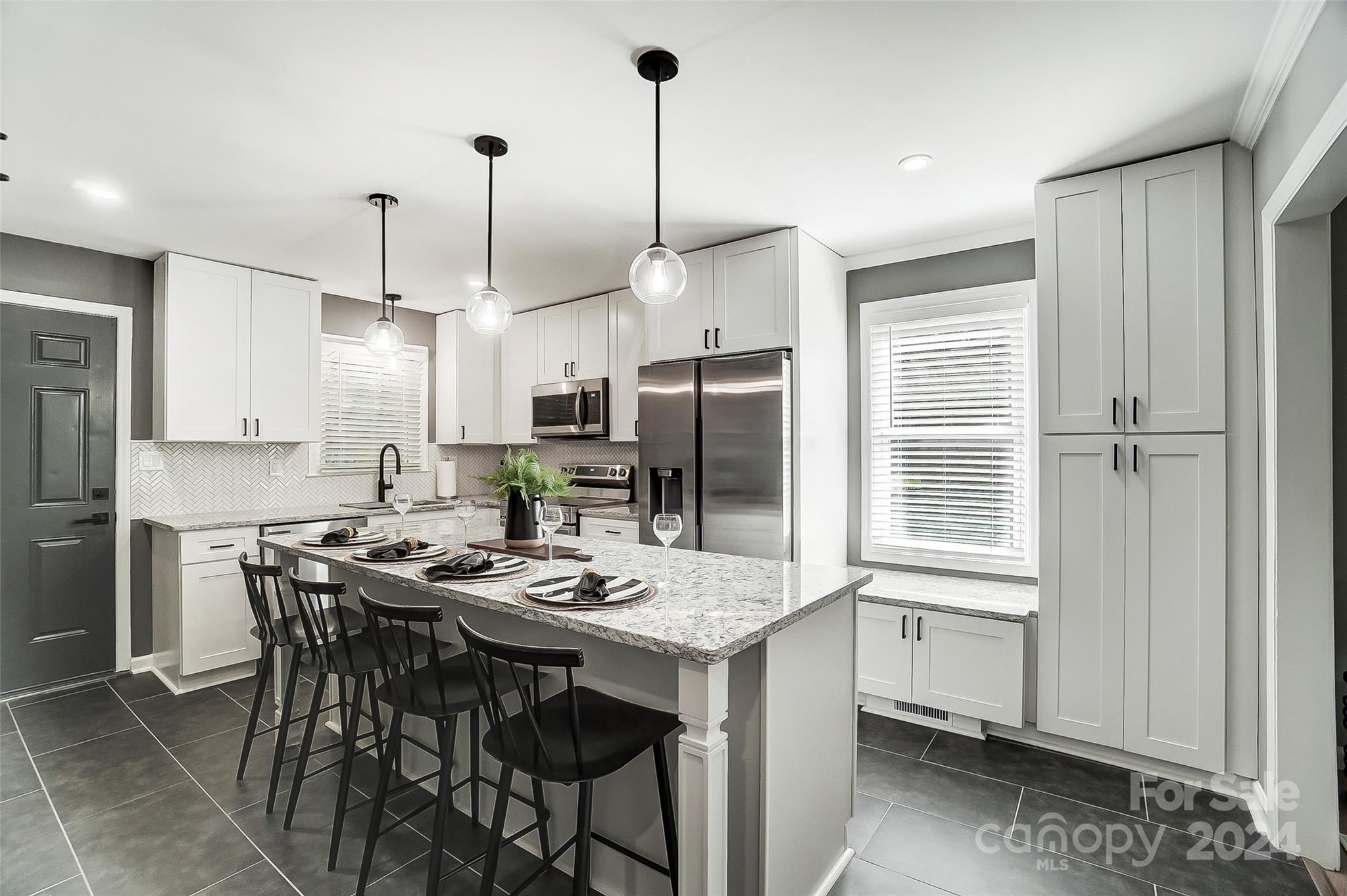 131 Hickory Lane York, SC 29745 - Photo 1 of 25 a kitchen with stainless steel appliances kitchen island granite countertop a table chairs and a refrigerator