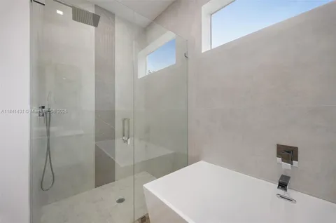 a bathroom with a shower and a sink