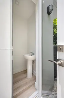 a view of a house with a yard and large tree