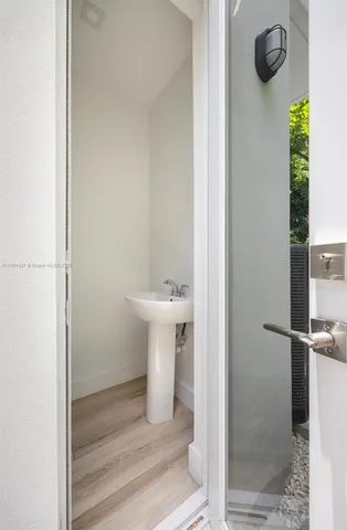 a view of a house with a yard and large tree