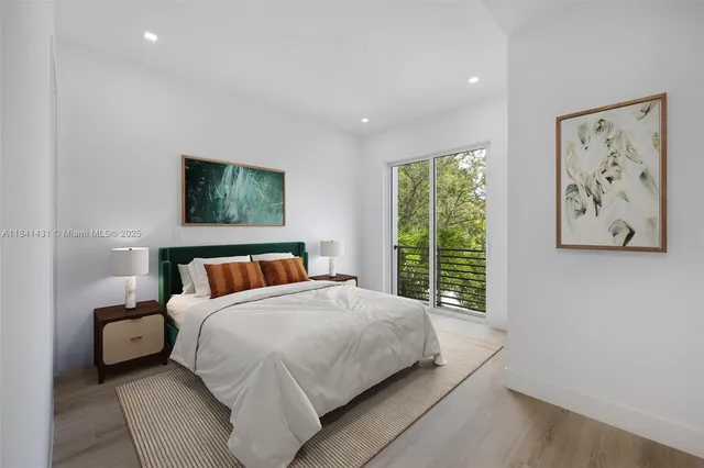 a bedroom with a large bed and a window