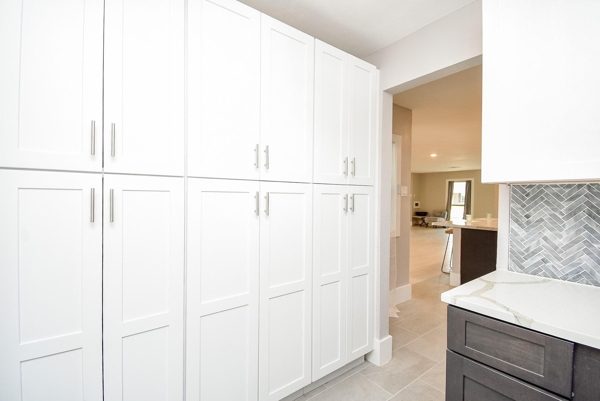 7618 Highmeadow Drive Houston, TX 77063 - Photo 17 of 48 a kitchen with a refrigerator and white cabinets
