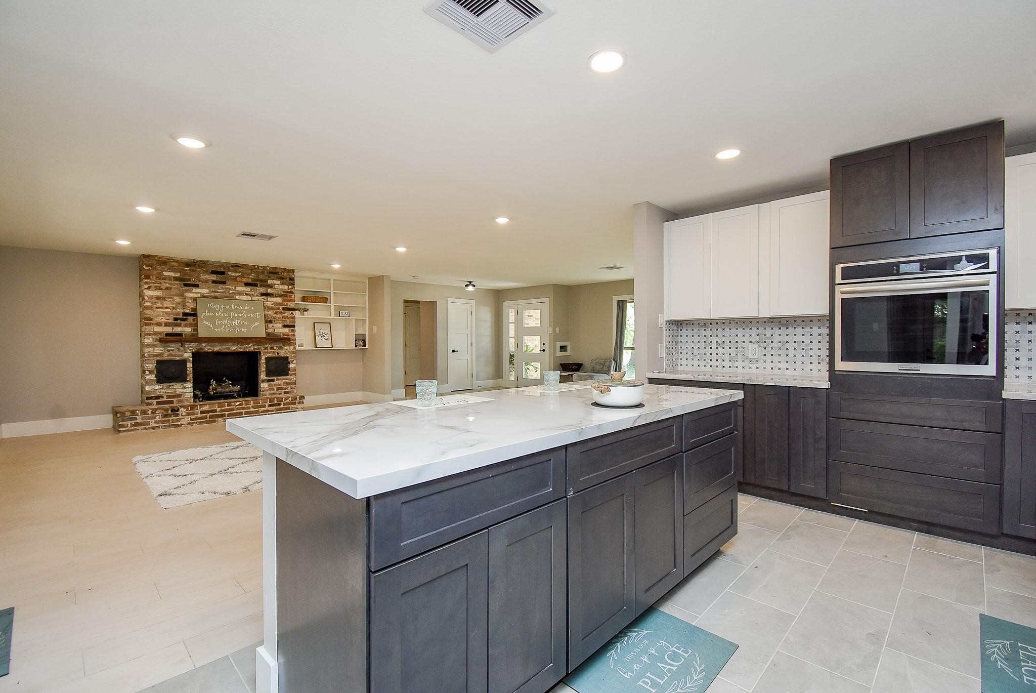 7618 Highmeadow Drive Houston, TX 77063 - Photo 18 of 48 a large kitchen with kitchen island a sink stainless steel appliances and cabinets