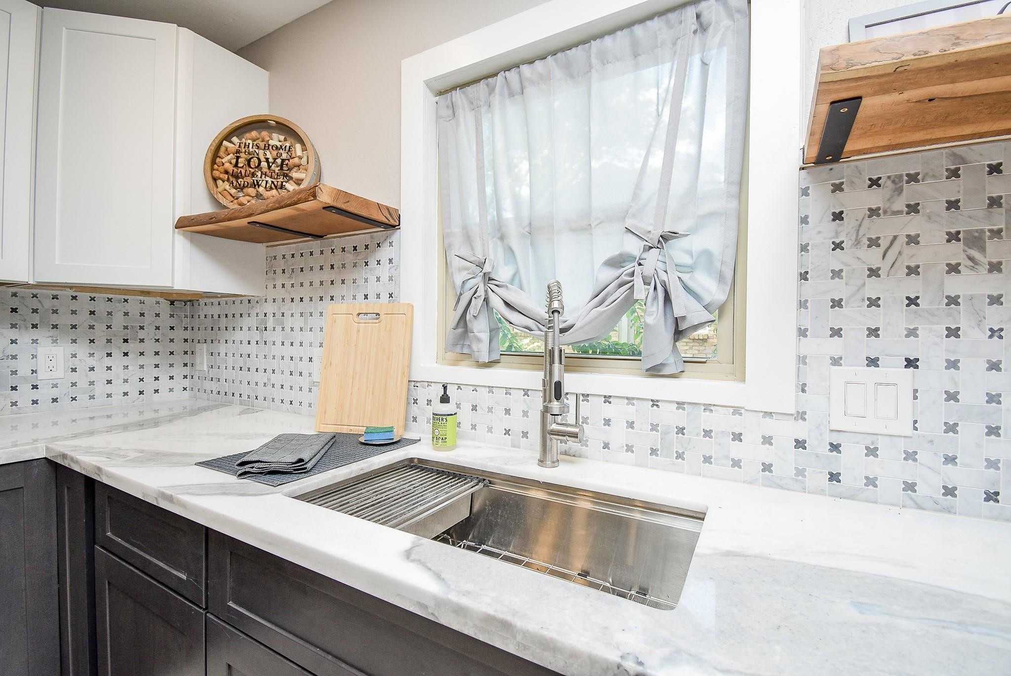 7618 Highmeadow Drive Houston, TX 77063 - Photo 19 of 48 a kitchen with a sink a stove and a window