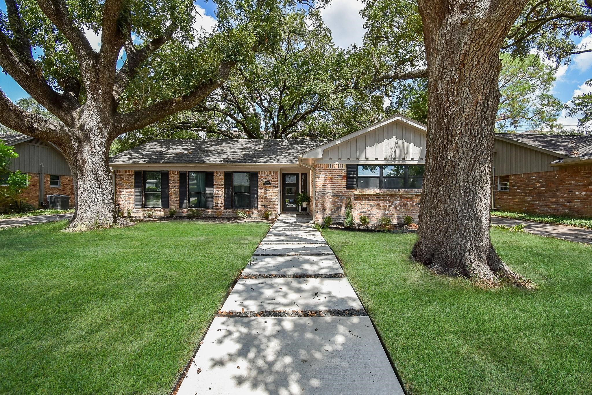 7618 Highmeadow Drive Houston, TX 77063 - Photo 2 of 48 a front view of a house with a yard and garden