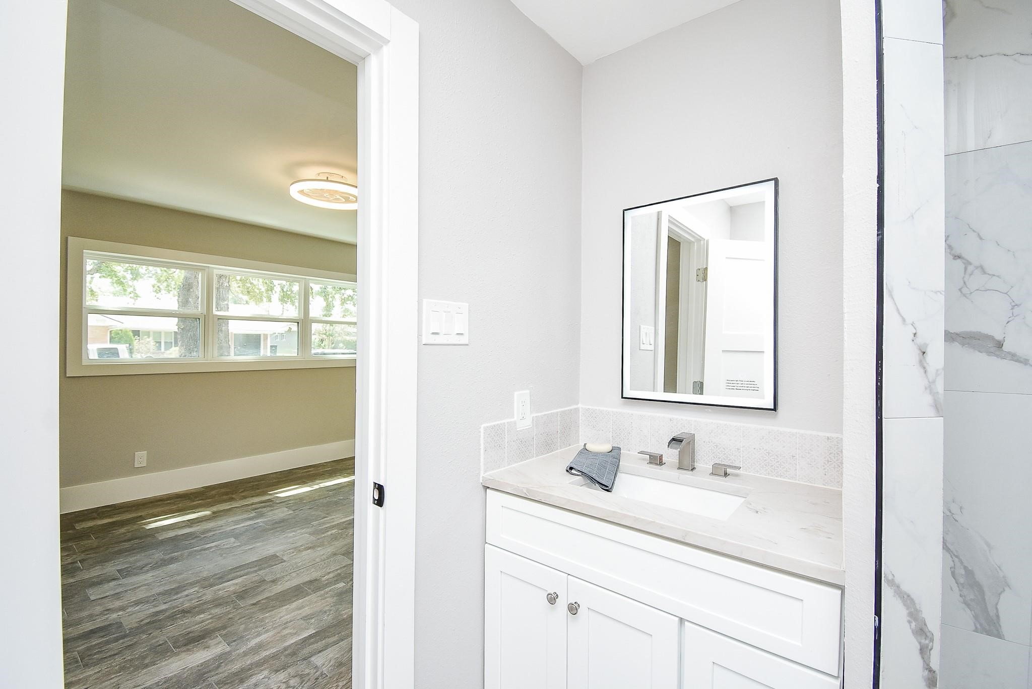 7618 Highmeadow Drive Houston, TX 77063 - Photo 21 of 48 a bathroom with a sink and a mirror