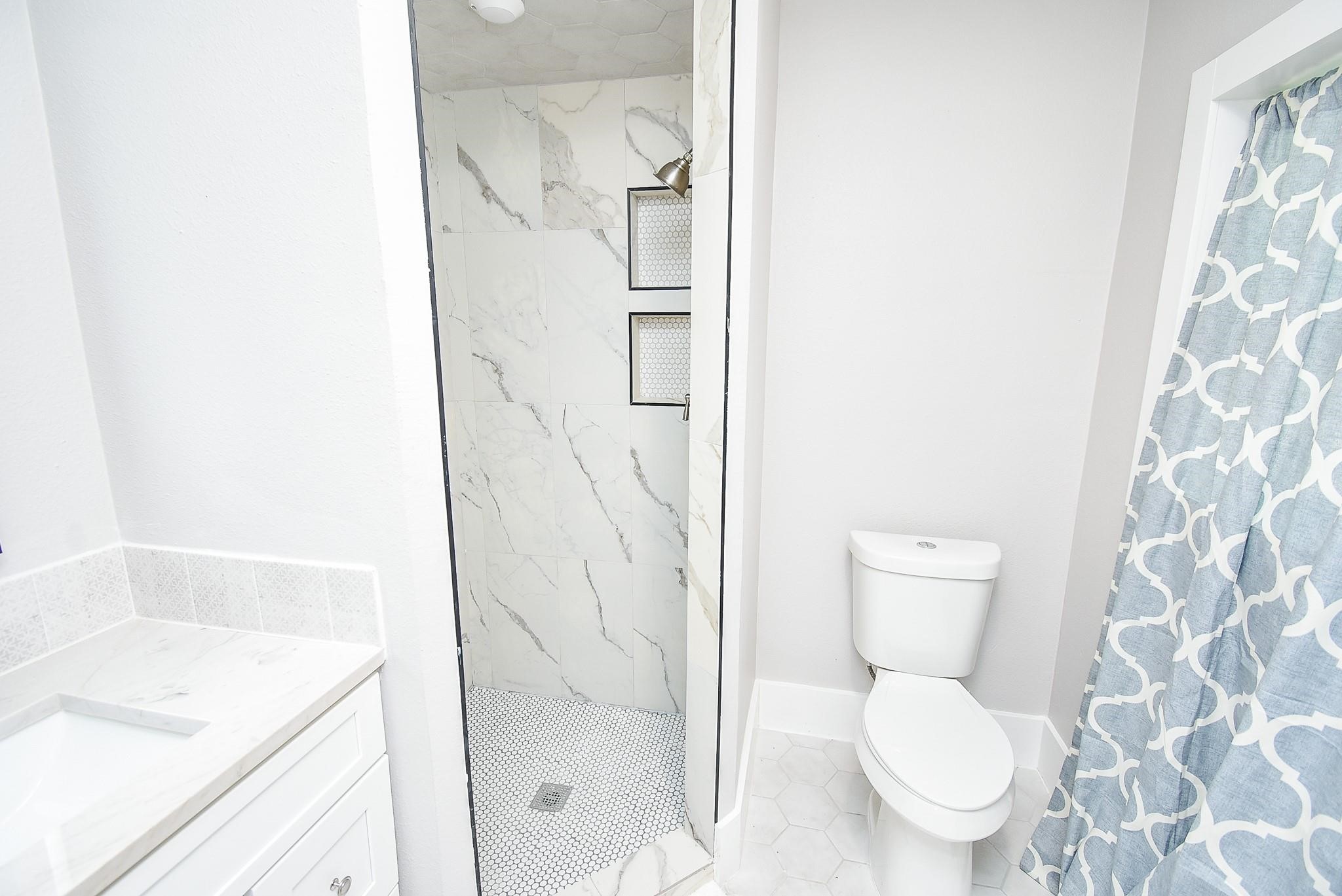 7618 Highmeadow Drive Houston, TX 77063 - Photo 23 of 48 a white toilet sitting next to a bathroom sink