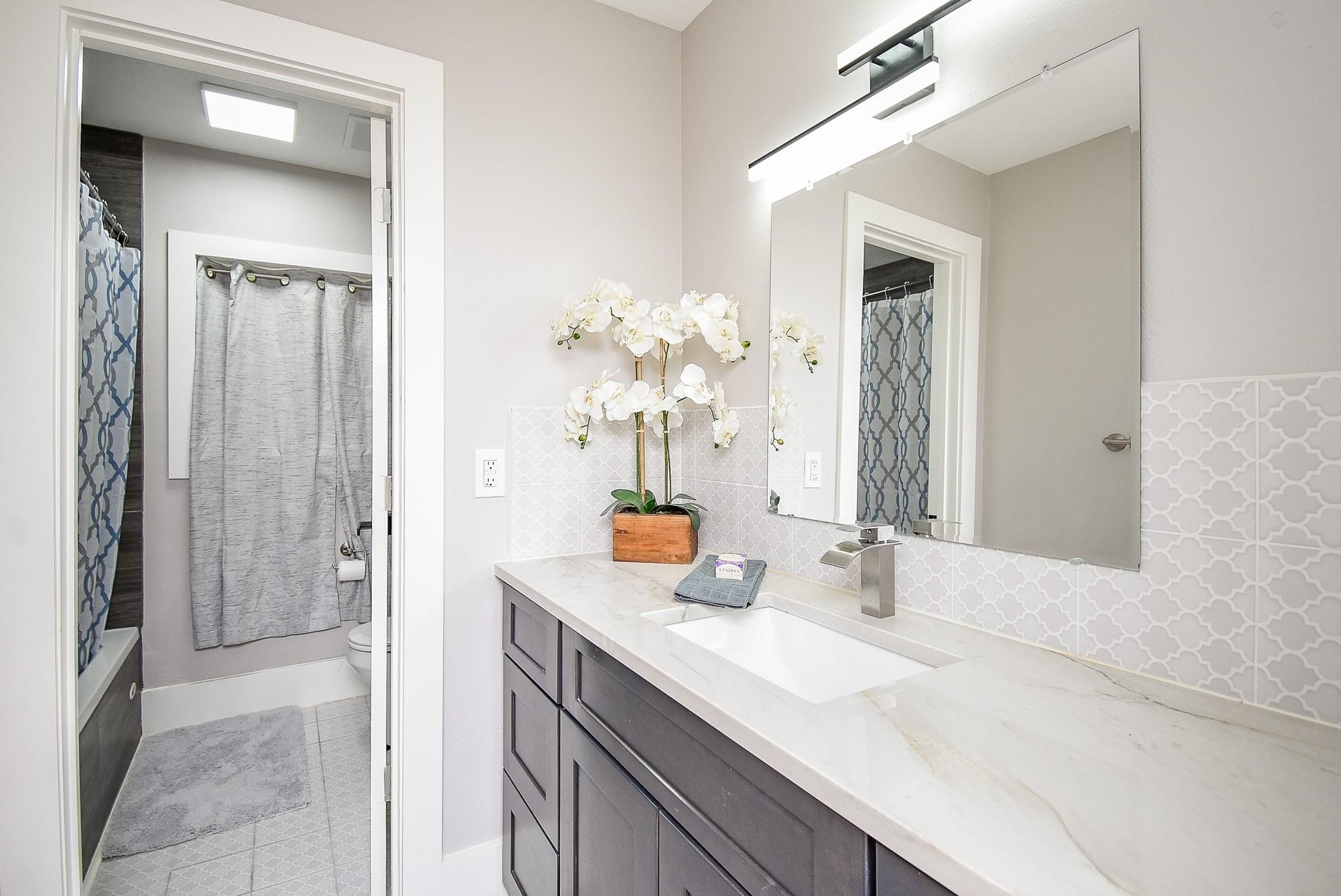 7618 Highmeadow Drive Houston, TX 77063 - Photo 26 of 48 a bathroom with a sink a vanity and a mirror