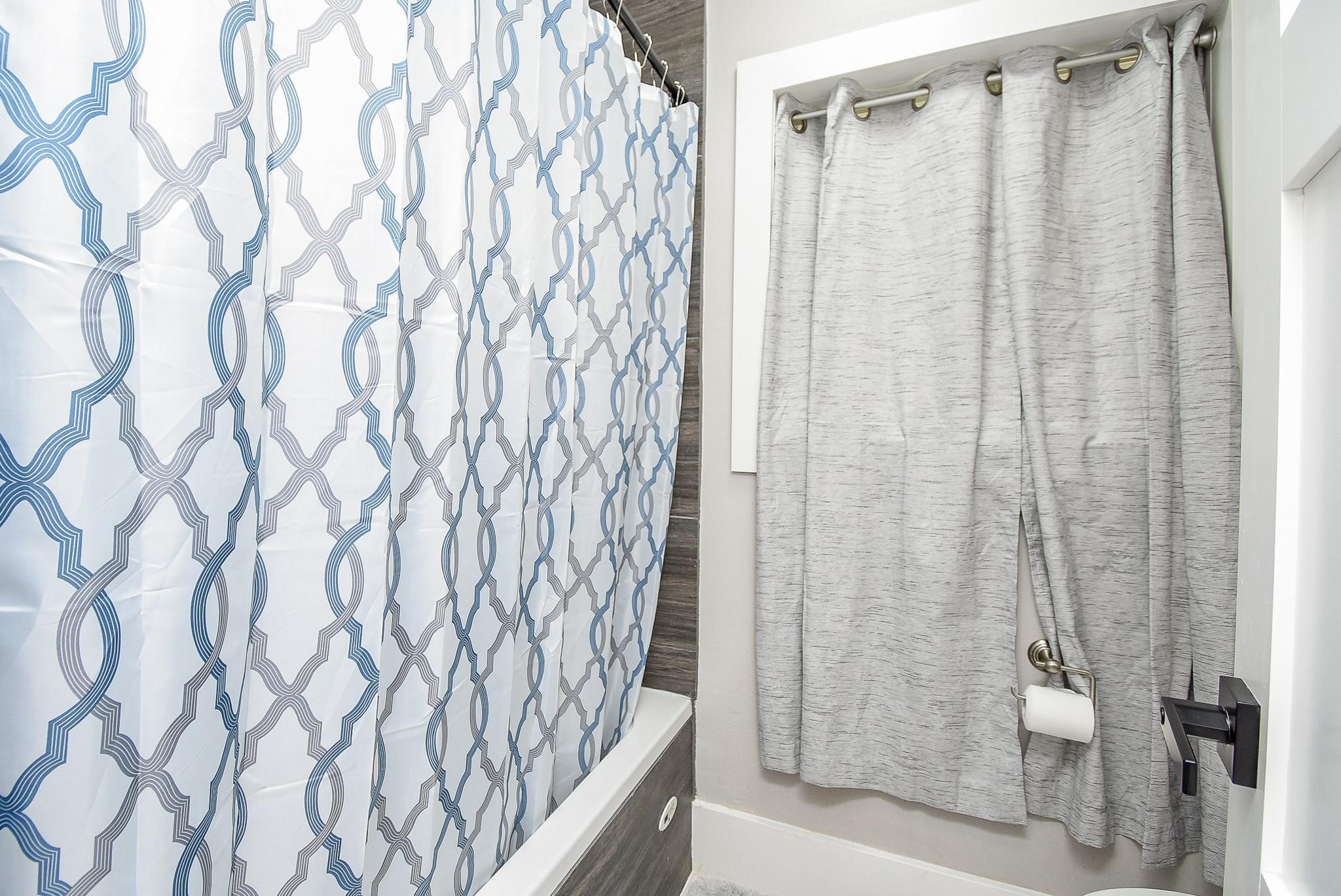 7618 Highmeadow Drive Houston, TX 77063 - Photo 29 of 48 a bathroom with a shower curtain and a curtain
