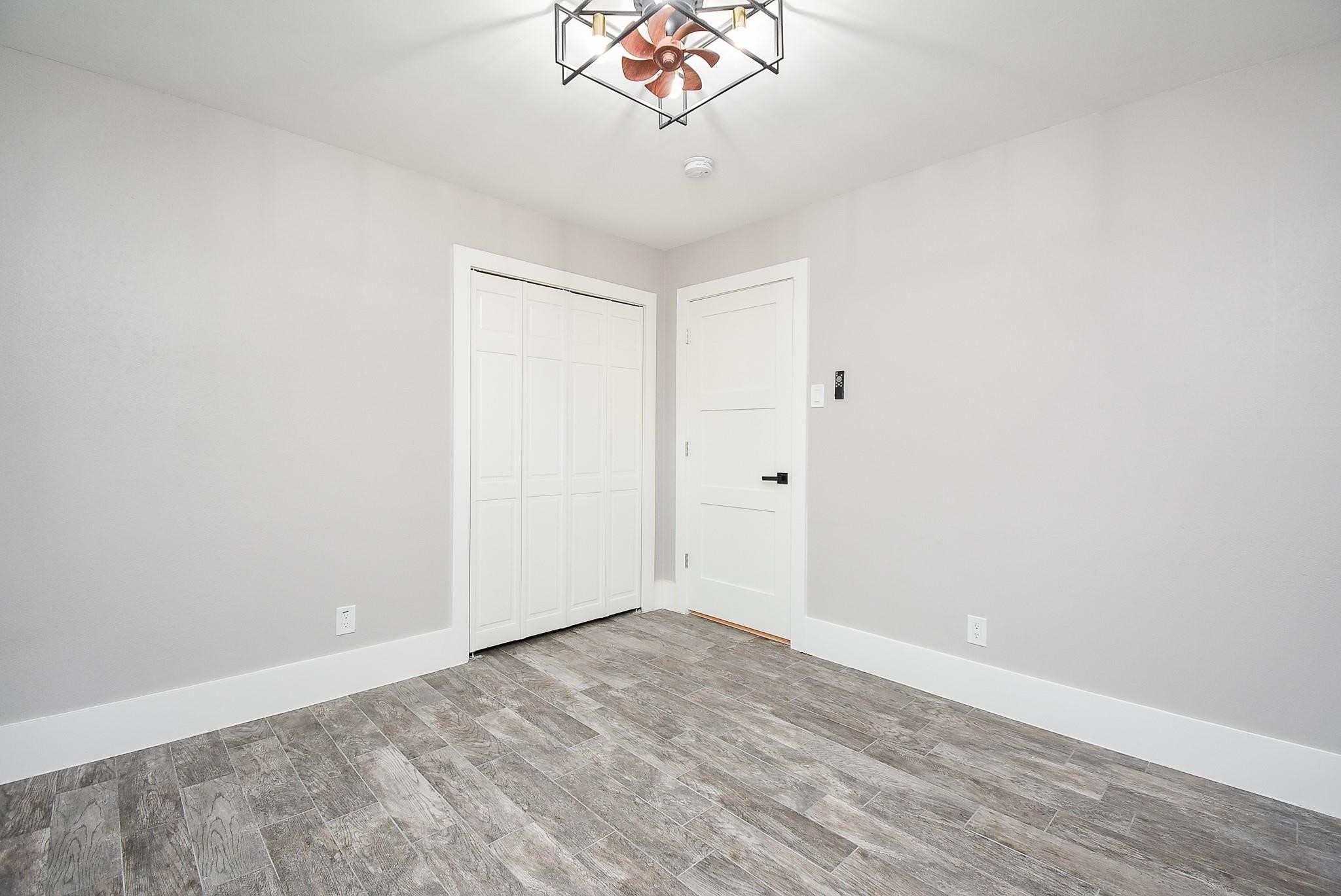 7618 Highmeadow Drive Houston, TX 77063 - Photo 32 of 48 a view of a room with wooden floor and a chandelier