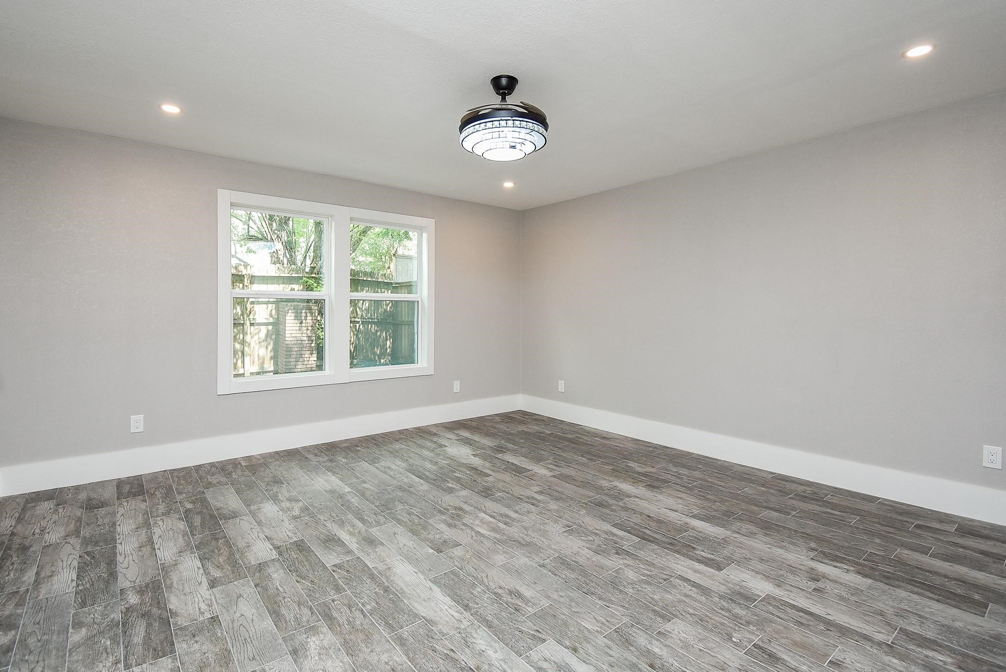 7618 Highmeadow Drive Houston, TX 77063 - Photo 37 of 48 wooden floor in an empty room with a window