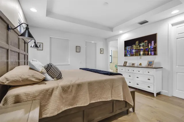 a spacious bathroom with a double vanity sink a mirror a bathtub and shower