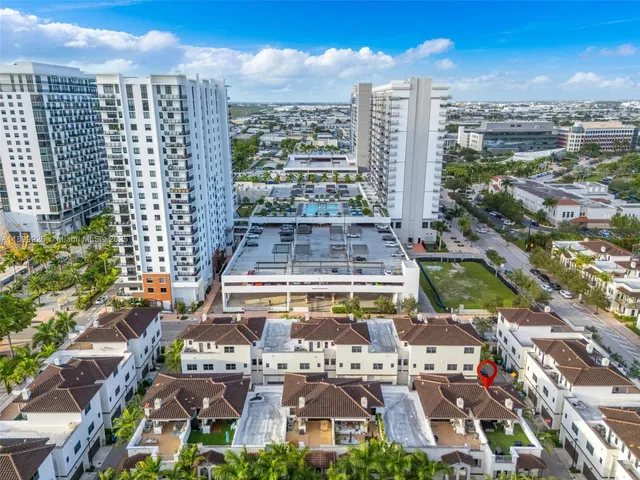 a view of a house with a yard and fountain in middle of the house
