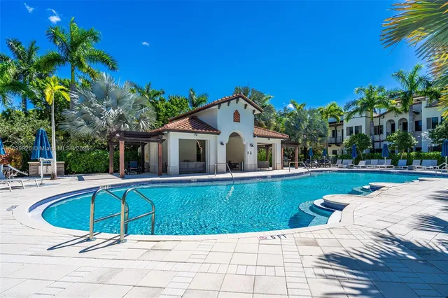 a front view of a house with garden and trees