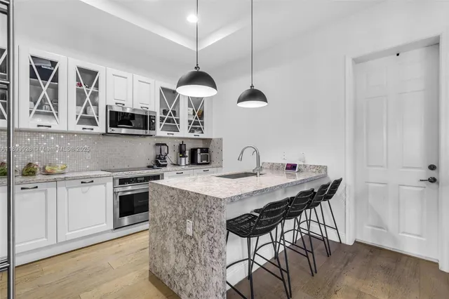 a living room with furniture window and wooden floor