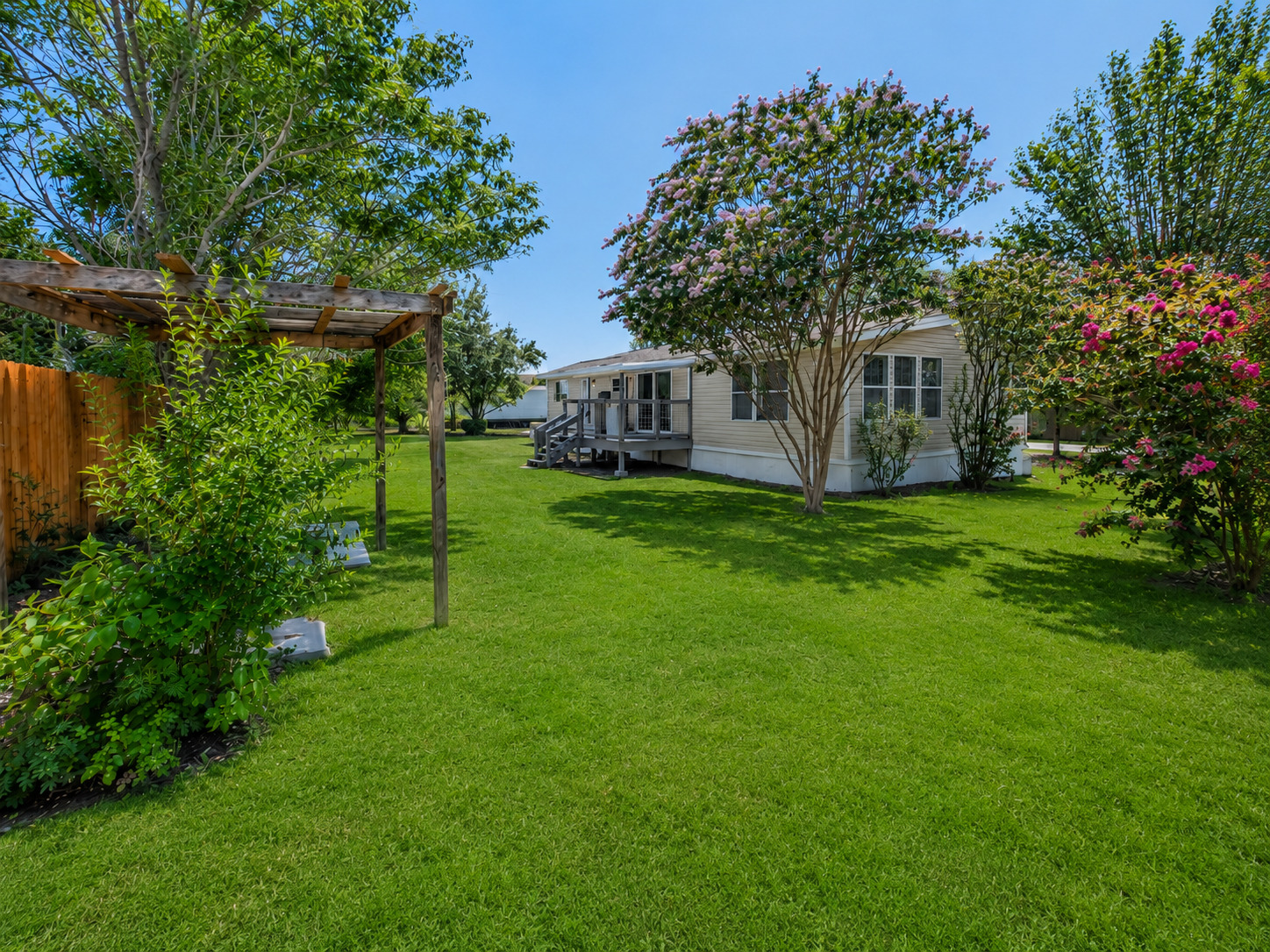 171 Railyard Drive Kyle, TX 78640 - Photo 4 of 20 a view of a house with a big yard potted plants and large tree