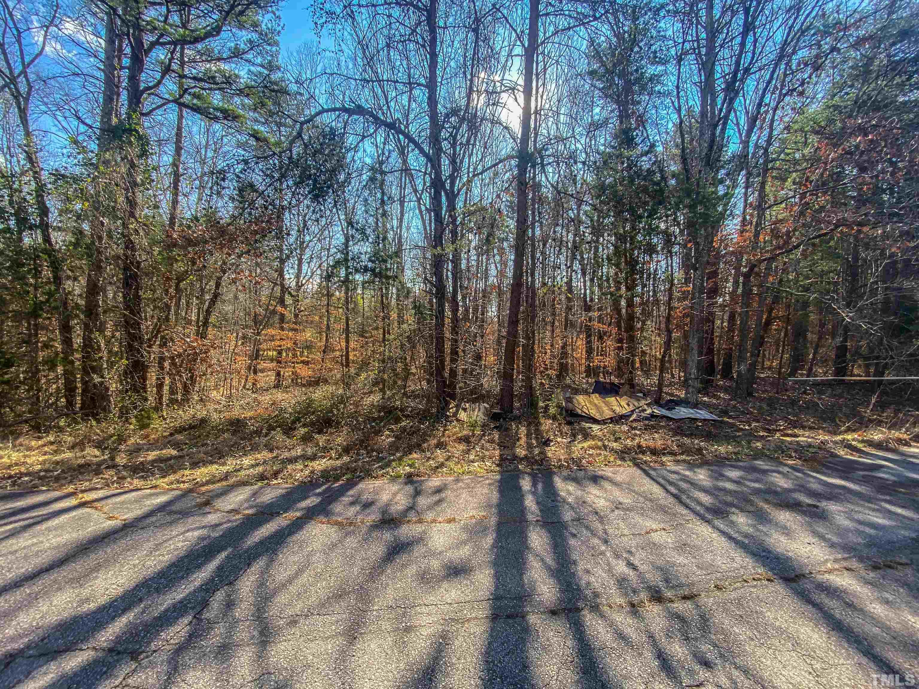 1.95-acre Archie Clayton Road Roxboro, NC 27574 - Photo 3 of 21 a view of a yard with wooden fence