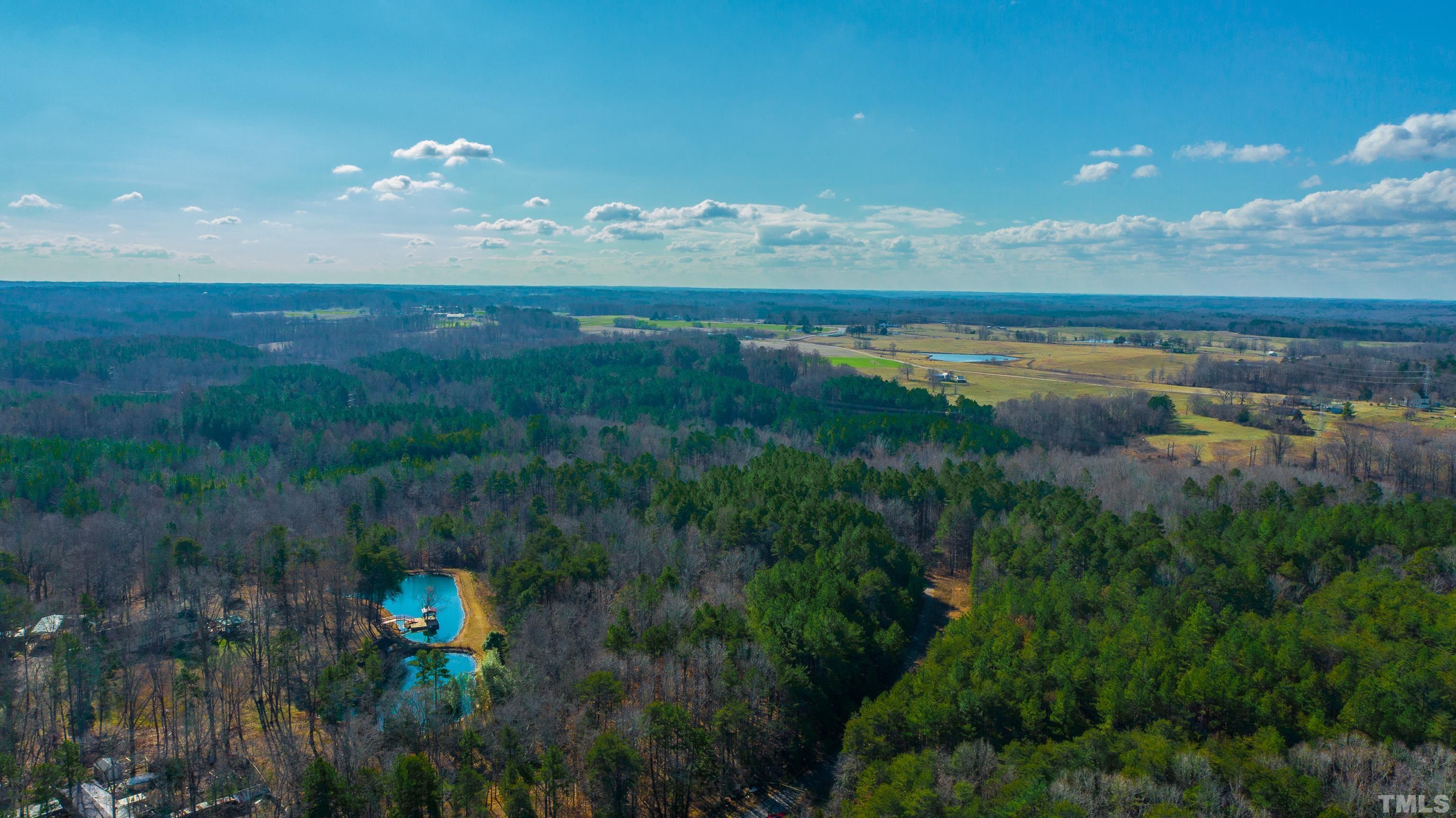 1.95-acre Archie Clayton Road Roxboro, NC 27574 - Photo 5 of 21 a view of a lake in middle of forest