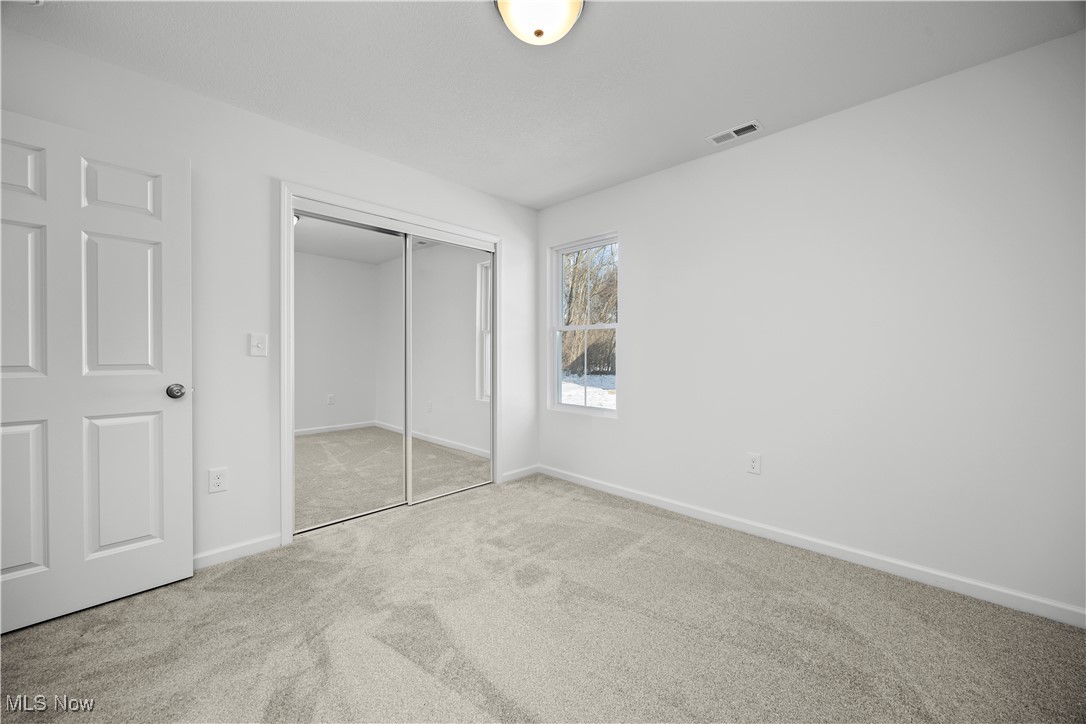 1999 East Oldgate Road Sandusky, OH 44870 - Photo 26 of 32 Unfurnished bedroom featuring carpet flooring and a closet