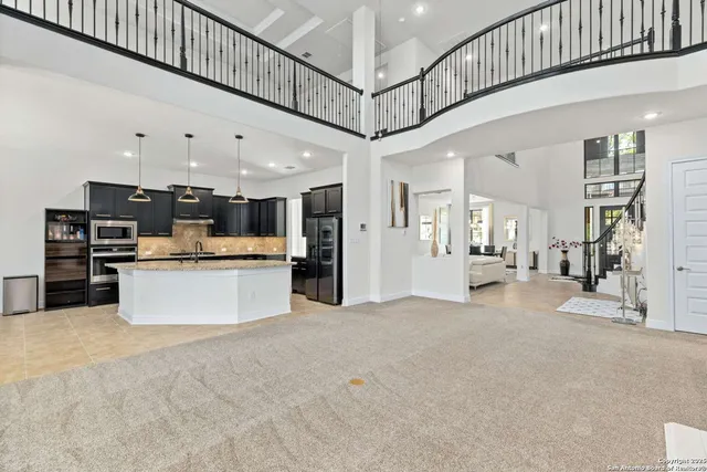 a kitchen with stainless steel appliances granite countertop a sink and a stove