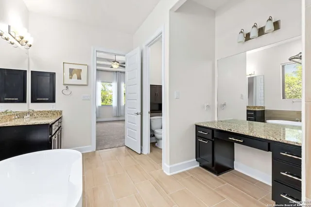 a view of staircase with lots of frames on wall and windows