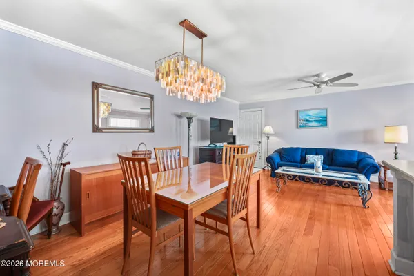 a view of a dining room with furniture wooden floor and chandelier