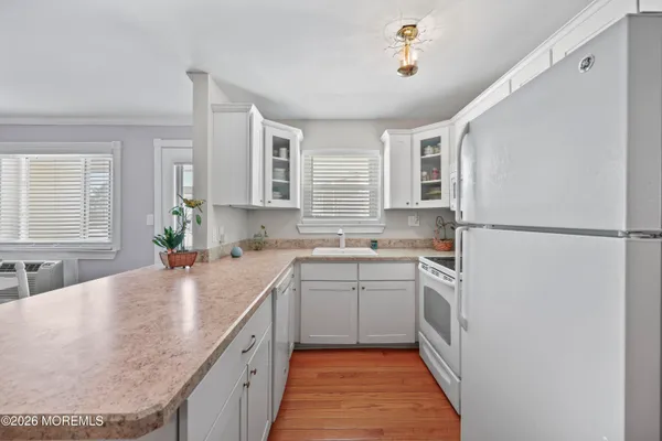 a kitchen with a sink stove and refrigerator