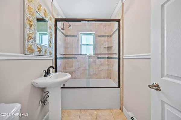 a bathroom with a sink a mirror and a shower