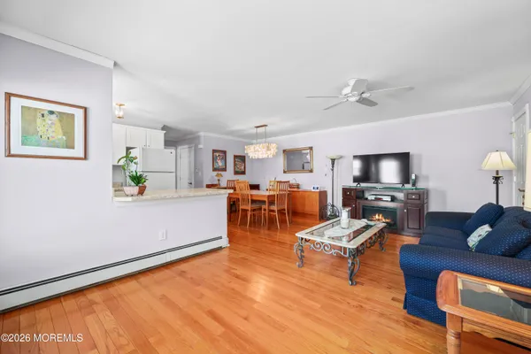 a living room with furniture and a wooden floor