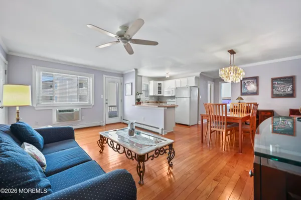 a living room with furniture a dining table and a window