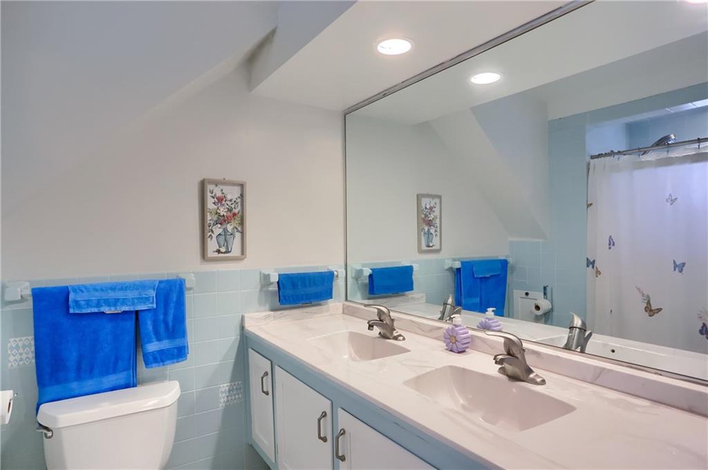 212 Tulagi Way New Castle, PA 16105 - Photo 19 of 30 a bathroom with a toilet a sink and a large mirror