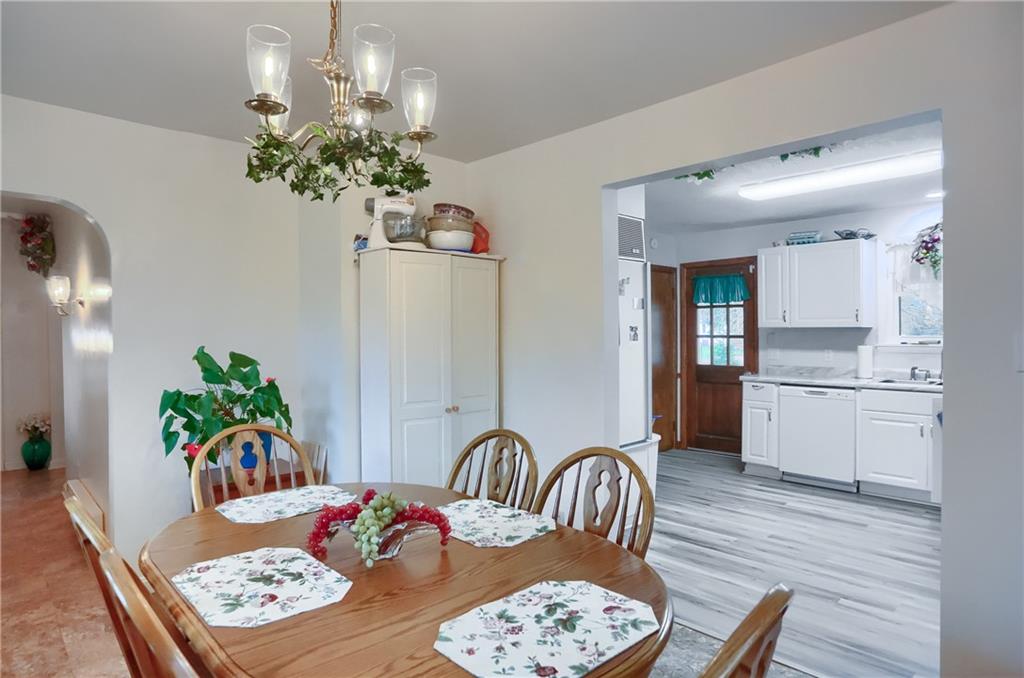 212 Tulagi Way New Castle, PA 16105 - Photo 5 of 30 a view of a dining room and kitchen with furniture wooden floor and a chandelier