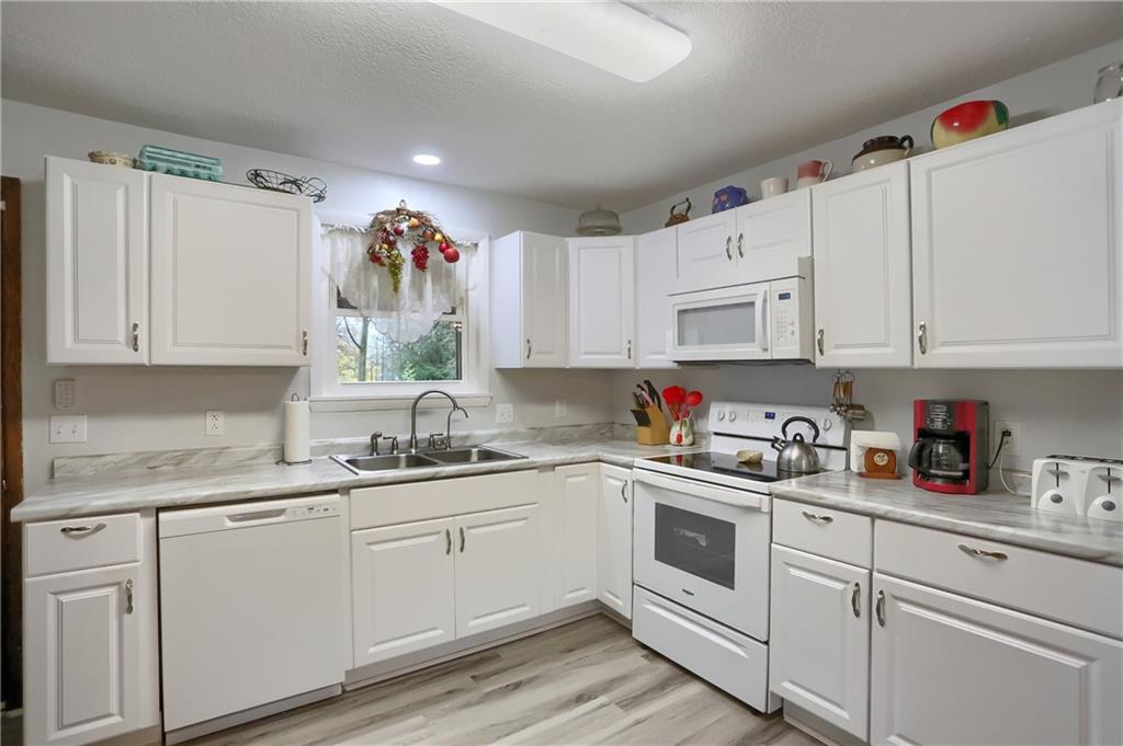 212 Tulagi Way New Castle, PA 16105 - Photo 7 of 30 a kitchen with white cabinets white stainless steel appliances and sink