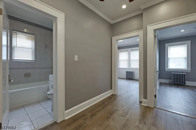 a view of a bathroom with a tub shower and a window