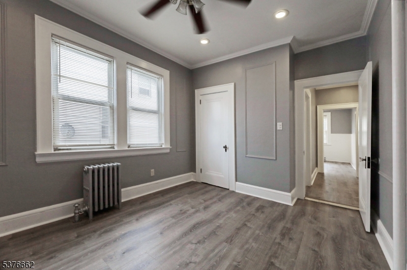 90 Norman Road Newark, NJ 07106 - Photo 21 of 31 a view of an empty room with wooden floor and a window